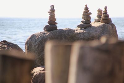 Close-up of rocks on beach against sky