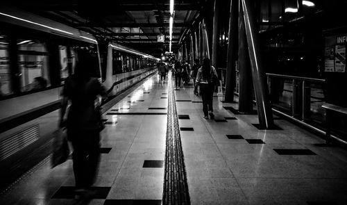 People walking on railroad station platform