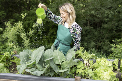 Full length of woman holding fresh plants