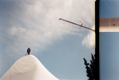 Low angle view of man standing against sky