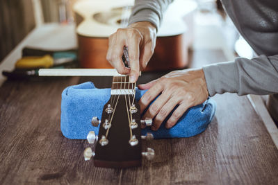 Man playing guitar on table