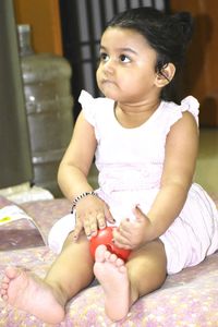 Cute baby girl sitting at home