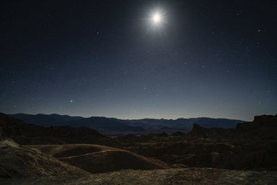 Scenic view of mountains against sky at night