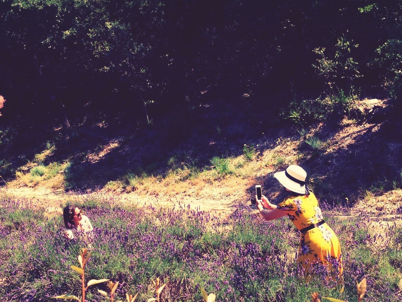 MAN AND WOMAN ON FIELD BY TREE