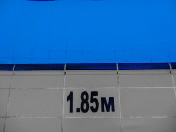 Close-up of text on blue wall