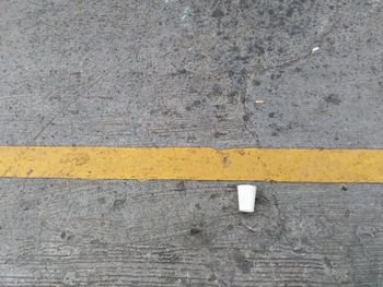 High angle view of yellow crossing sign on road