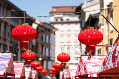 Red lanterns hanging by building in city