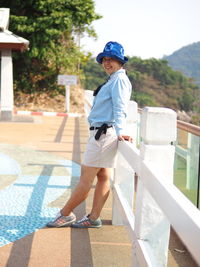 Full length of boy standing against wall