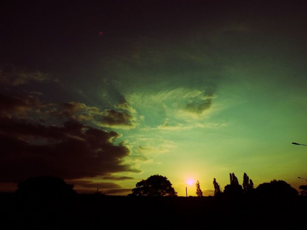 sunset, silhouette, sky, sun, beauty in nature, scenics, tranquil scene, orange color, tranquility, cloud - sky, nature, idyllic, sunlight, cloud, outdoors, dark, low angle view, dramatic sky, no people, outline