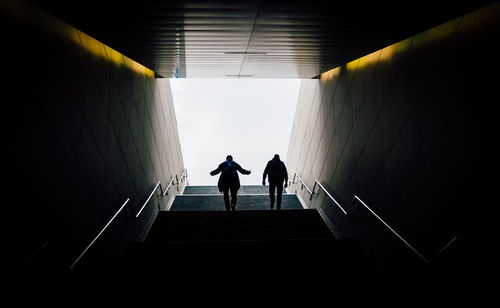 Low angle view of men walking on steps