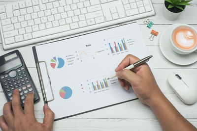 Low section of man working on table