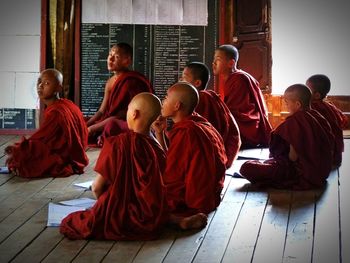 View of people sitting on wall