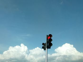 Low angle view of road signal against sky