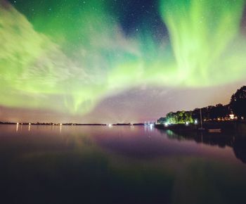 Scenic view of sea against dramatic sky at night