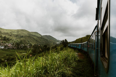 Train on land against cloudy sky