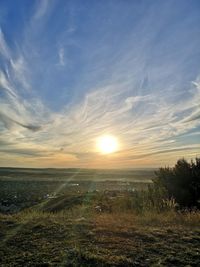 Scenic view of land against sky during sunset