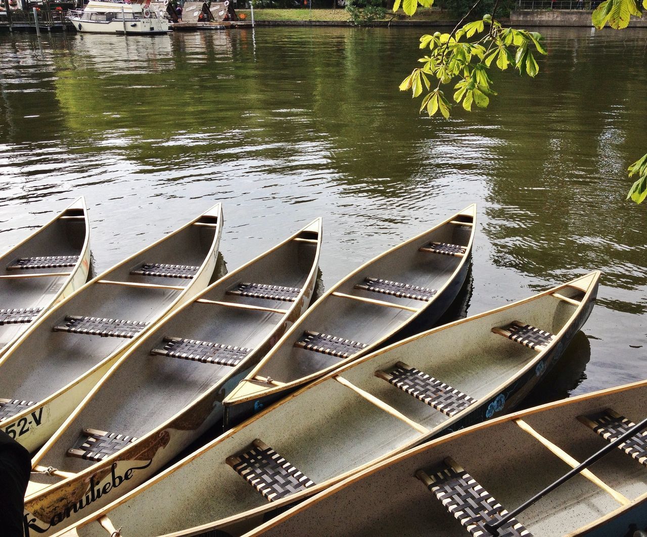 water, high angle view, river, day, lake, built structure, boat, no people, outdoors, sunlight, nature, nautical vessel, text, transportation, architecture, table, chair, waterfront, elevated view, connection