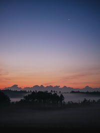 Venus shining above misty landscape in early morning