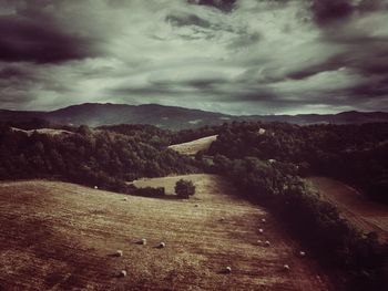 Scenic view of mountains against cloudy sky