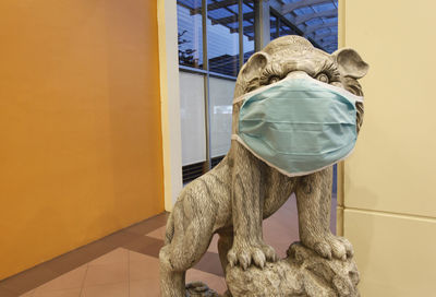 A lion statue using face mask at a shopping mall in bogor, west java, indonesia