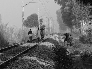 People walking on railroad track