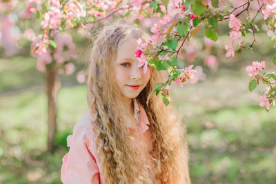 Portrait of woman with pink flower