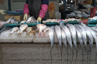 Man standing in fish for sale at market