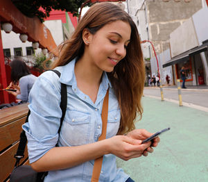 Young woman using mobile phone