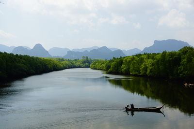 Scenic view of lake with mountains in background