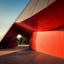 Red umbrella against sky