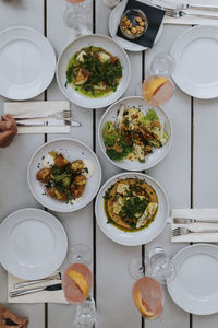 Directly above shot of food and drinks on table at restaurant