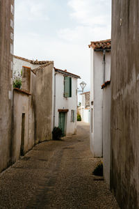 Empty alley amidst buildings in city