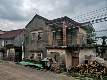 Houses against cloudy sky