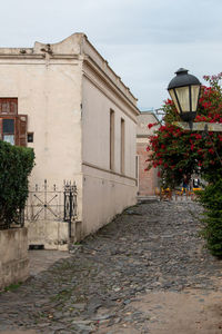 Street amidst buildings in town against sky