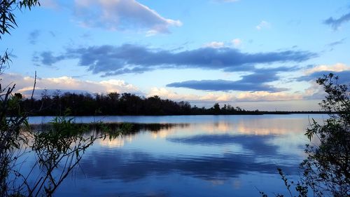 Scenic view of lake against sky at sunset