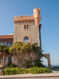 Low angle view of traditional building against clear blue sky