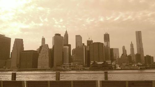 Cityscape against cloudy sky