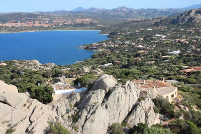 High angle view of sea and mountains against sky