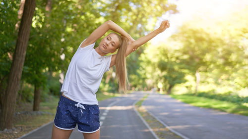 Full length of young woman standing in park