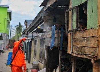 Rear view of men working on building