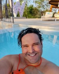 Portrait of smiling man in swimming pool