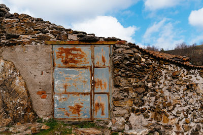 Graffiti on old wall against sky