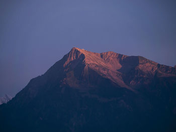 View of mountain range against blue sky