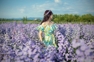 Rear view of woman standing on field