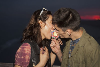 Young couple sharing a candy apple