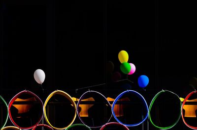 Close-up of colorful balloons against black background