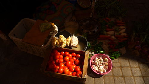 High angle view of tomatoes in box at market for sale