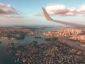 Aerial view of cityscape and sea against sky