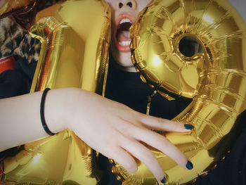 Woman holding number 19 helium balloons at party