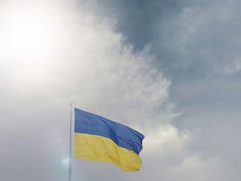 Low angle view of flag against sky